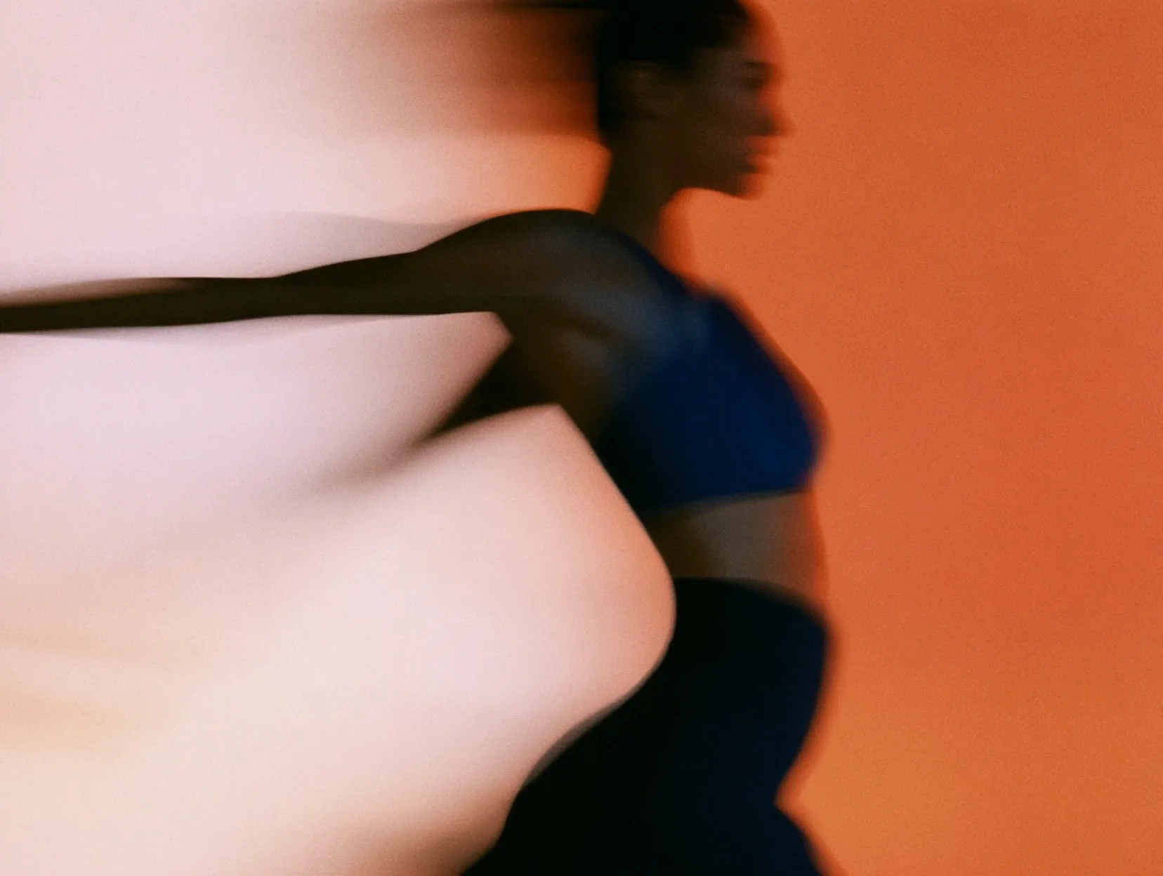 Runner moving through warm orange light